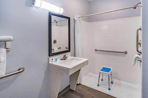 a bathroom with a sink and a mirror at Days Inn & Suites by Wyndham Horn Lake - Memphis Graceland in Horn Lake