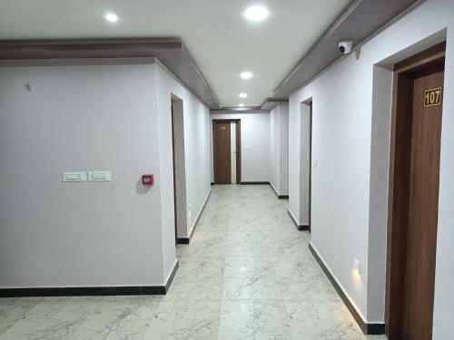 a corridor of an office with white walls and a door at Golden Peaks Hotel & Restaurant in Kalimpong