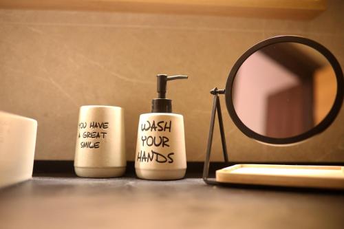 a bathroom counter with a blow dryer and a mirror at Woodside TEA Residences & SPA Kopaonik in Kopaonik