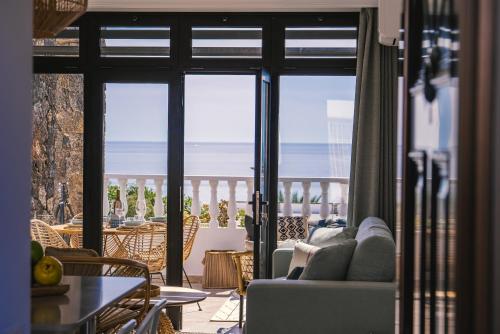 a living room with a couch and a view of the ocean at Casa Tucanes in Puerto del Carmen