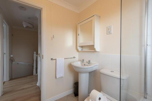 a bathroom with a sink and a toilet and a shower at Hillbrook in Thornaby on Tees