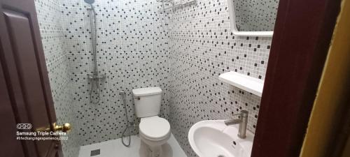 a bathroom with a toilet and a sink at Mano boutique sun shine in Luang Prabang