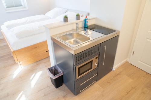 a small kitchen with a sink in a room at BACCO Bed & Breakfast in Rotenburg an der Fulda