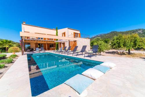 a villa with a swimming pool in front of a house at Ideal Property Mallorca - Sa Vinyeta in Selva