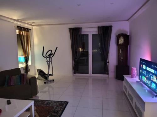 a living room with a couch and a tv at Beautiful terraced house with private parking in Sandviken