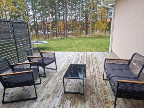 a patio with two chairs and a table and a table at Beautiful terraced house with private parking in Sandviken