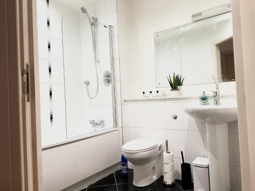 a bathroom with a shower and a toilet and a sink at The Temple House Balcony Suite in Birmingham