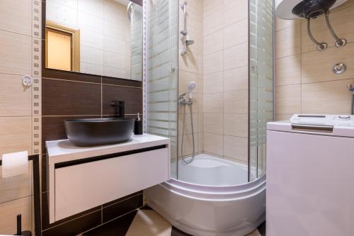 a bathroom with a sink and a shower at Madonna Sky in Kupres