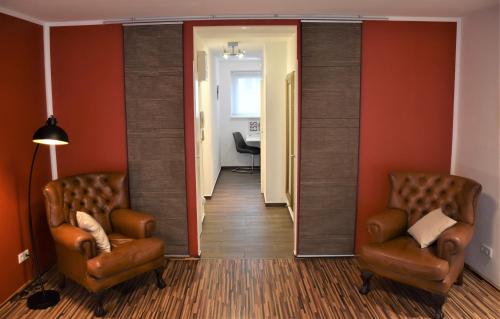 a hallway with two chairs and a mirror in a room at Studio-Apartment Augarten in Vienna