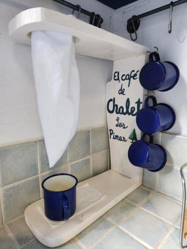 a toilet in a bathroom with a cup on it at Chalet los Pinos Constanza in Arroyo Frío
