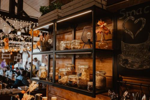 a shelf filled with jars of food in a restaurant at Noclegi JuraPark Krasiejów in Krasiejów