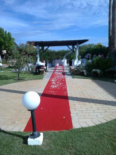 a red carpeted pathway with a pavilion in a park at Alte Hotel in Alte