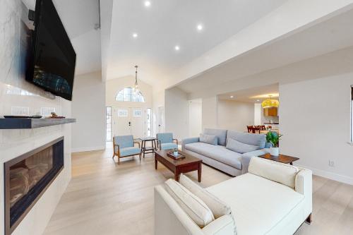 a living room with a couch and a fireplace at Pebble Beach Abundant Oasis in Pebble Beach