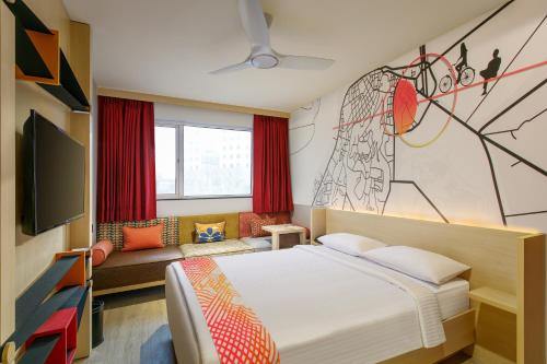 a bedroom with a bed and a couch at Ginger Nashik in Nashik