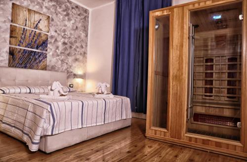 a bedroom with a bed and a glass door at Messina41 Hotel in Messina