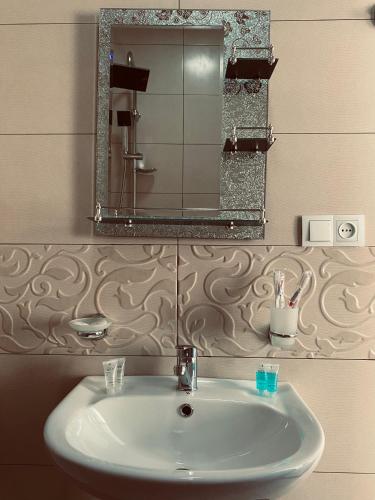 a bathroom with a sink and a mirror at Guesthouse Relax in Kazbegi in Stepantsminda