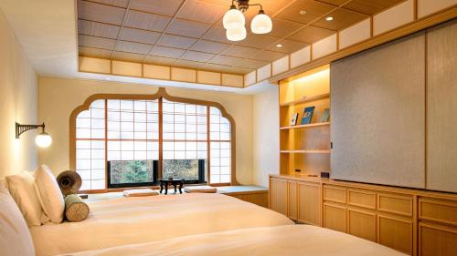 a bedroom with a large bed and a projection screen at Fufu Nikko in Nikko