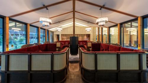 a waiting room with red chairs and windows at Fufu Nikko in Nikko