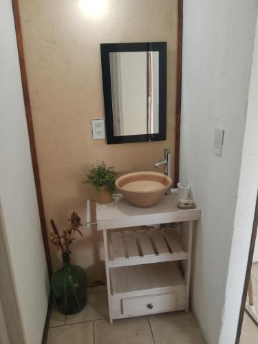 a bathroom with a bowl sink and a mirror at Umi del sur in Mar del Plata