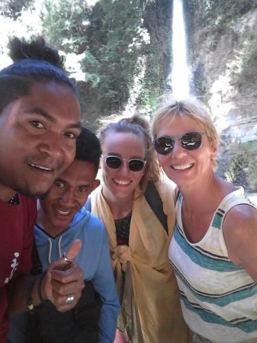 a group of three people posing for a picture at Kristian Homestay in Bajawa