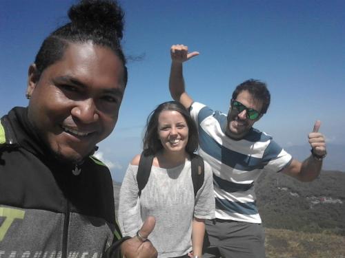 two men and a woman posing for a picture at Kristian Homestay in Bajawa