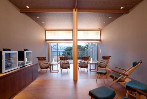 a dining room with a table and chairs at Atami Sekaie in Atami