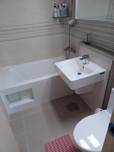 a bathroom with a sink and a tub and a toilet at GOOD VIEW Guest House in Jeonju