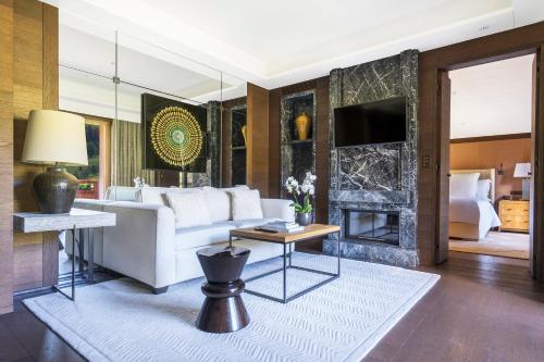 a living room with a white couch and a fireplace at Four Seasons Hotel Megeve in Megève