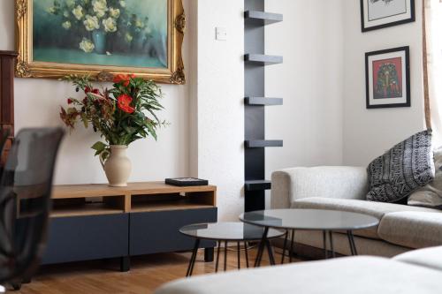 a living room with a couch and a table at Flat near Lord's Cricket Ground in London