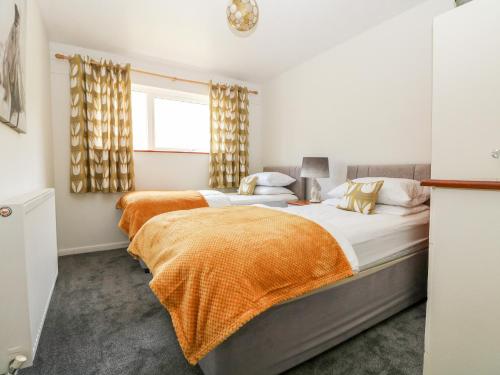 a bedroom with two beds and a window at Manorcombe 2 in Callington