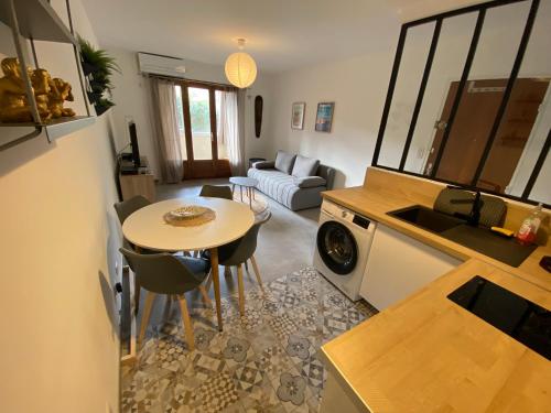 une cuisine et un salon avec une table et un canapé dans l'établissement Appartement T2 Cosy sur Aix, à Aix-en-Provence
