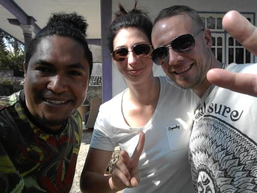 two men and a woman posing for a picture at Kristian Homestay in Bajawa