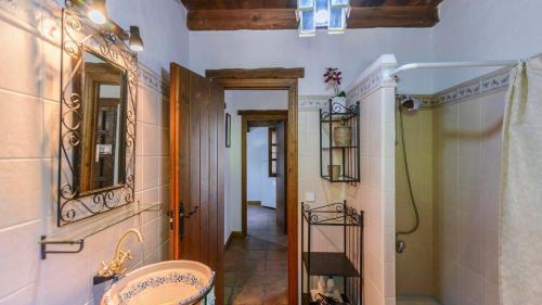 a bathroom with a sink and a mirror at Molino La Catedral Grazalema by Ruralidays in Grazalema