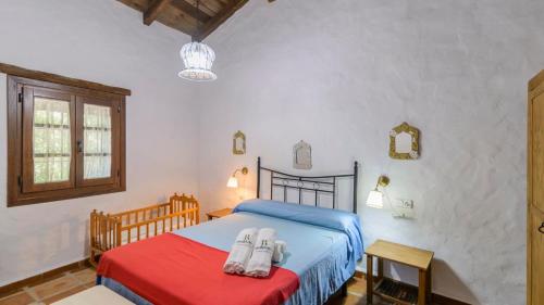 a bedroom with a bed with shoes on it at Molino La Catedral Grazalema by Ruralidays in Grazalema