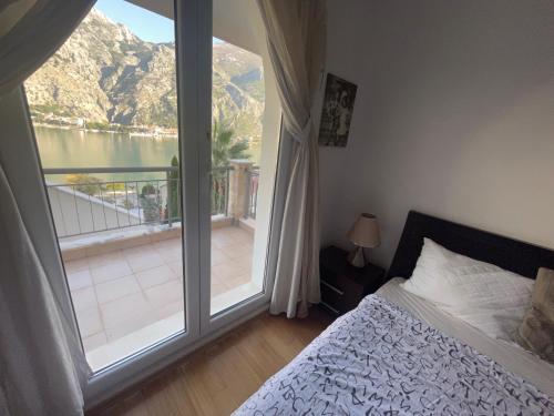 a bedroom with a bed and a large window at Stunning view to Kotor bay and Old town - C2 Vista in Muo