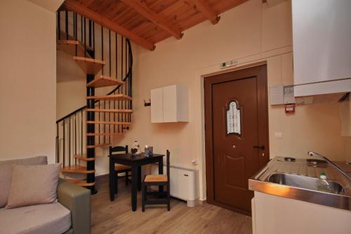 a kitchen with a sink and a table in a room at Valtessiniko Studios in Valtessiniko