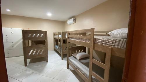 a room with four bunk beds in a room at Hostel Mar in São Luís