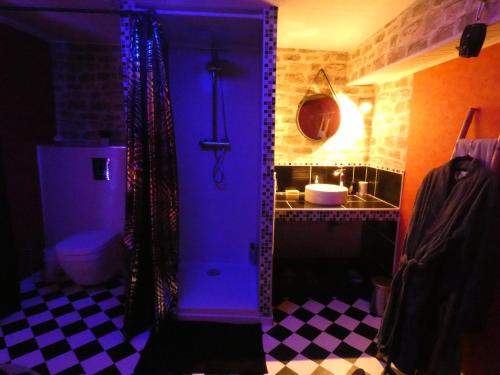 een badkamer met een blauwe deur met een wastafel en een toilet bij LOVE ROOM Le rouge et noir in Barr