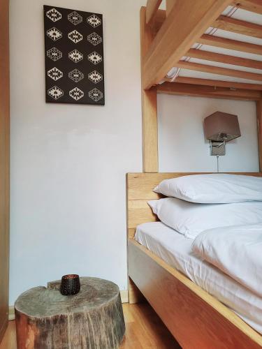 a bedroom with a bed and a table next to it at Apartment U245 in aparthotel Vucko - private host in Jahorina
