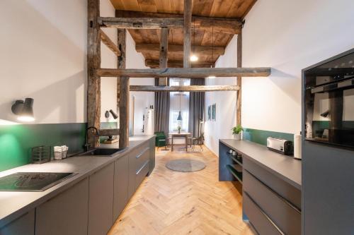 cocina grande con techo de madera y suelo de madera en TORhaus Appartments Sendenhorst, en Sendenhorst