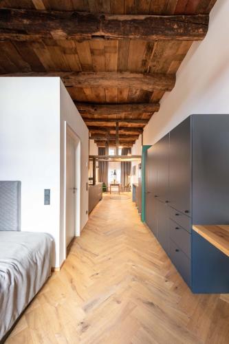 a bedroom with a bed and a wooden ceiling at TORhaus Appartments Sendenhorst in Sendenhorst