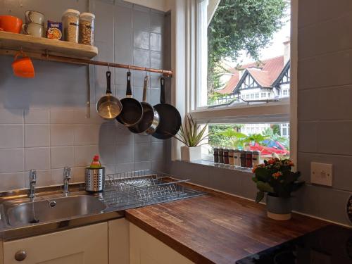 a kitchen with a sink and a window at *Unique Brighton Apartment & Garden, near Beach* in Brighton & Hove