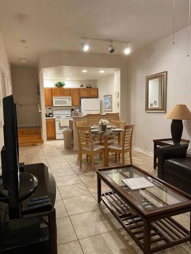 a living room with a table and a dining room at Family Friendly 3BR near Disney in Kissimmee