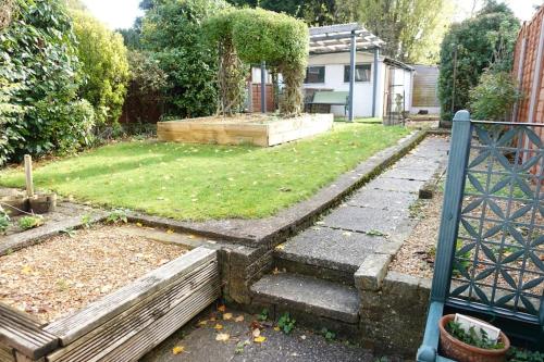 a backyard with a garden with a yard with stairs at Stylish 3 Bedroom House Near NEC, City Centre in Birmingham