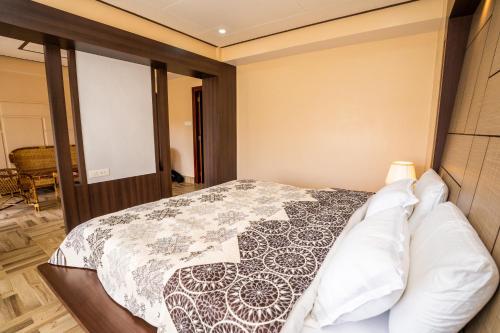 a bedroom with a bed with a black and white quilt at East Land Bed & Breakfast in Shillong