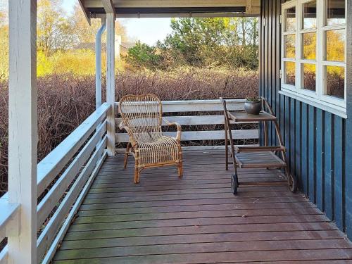 a porch with two chairs and a table on it at 6 person holiday home in Glesborg in Glesborg