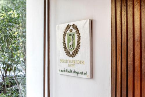 a sign on a wall next to a window at Forest Park Hotel in Platres