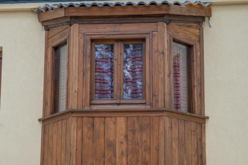 a wooden window on the side of a building at villa Melissa in Kostitsi