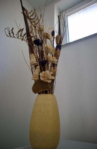 a vase with flowers in it sitting on a table at GOT Prishtina Hostel in Pristina