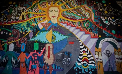 a wall with a painting of a woman on it at GOT Prishtina Hostel in Pristina